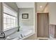 Bright bathroom featuring a soaking tub and a separate shower with a neutral color palette at 25 Grange Way, Sharpsburg, GA 30277