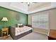 Cozy bedroom with green accent wall, ample natural light, and a neutral color palette at 25 Grange Way, Sharpsburg, GA 30277