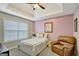 Bedroom with a tray ceiling, a leather chair, and a window with natural light at 25 Grange Way, Sharpsburg, GA 30277