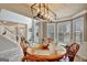 Dining room with a large table, ample seating, and natural light from large windows at 25 Grange Way, Sharpsburg, GA 30277
