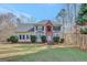 Two-story home with brick accent and well-manicured lawn under a clear blue sky at 25 Grange Way, Sharpsburg, GA 30277