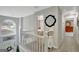 Upstairs hallway with a view of the foyer and multiple bedrooms at 25 Grange Way, Sharpsburg, GA 30277