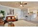Comfortable living room with hardwood floors, ceiling fan, leather couch, and access to the bright, white kitchen at 25 Grange Way, Sharpsburg, GA 30277
