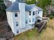 Rear exterior view of a two-story home with a wooden deck and a spacious backyard at 25 Grange Way, Sharpsburg, GA 30277