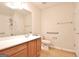 Bathroom features a large mirror, cherry cabinet and tub/shower combo with a hand-held showerhead at 430 Rehobeth Way, Fayetteville, GA 30214