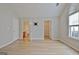 Bright bedroom features wood-look flooring, a TV mount, and entrances to a closet and ensuite bathroom at 430 Rehobeth Way, Fayetteville, GA 30214