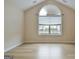 Bright bedroom with a large arched window and stylish wood-look floors at 430 Rehobeth Way, Fayetteville, GA 30214