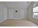 Bright bedroom features wood-look flooring, TV mount, and a large window at 430 Rehobeth Way, Fayetteville, GA 30214