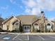 Community clubhouse with stone and siding exterior and mature landscaping at 430 Rehobeth Way, Fayetteville, GA 30214