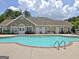 Outdoor pool area with pristine water and a clubhouse, offering a perfect amenity for residents at 430 Rehobeth Way, Fayetteville, GA 30214