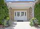 Entrance to community clubhouse with stone exterior and mature landscaping at 430 Rehobeth Way, Fayetteville, GA 30214