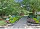 Picturesque outdoor gazebo surrounded by lush greenery and colorful flower beds, set along a pathway at 430 Rehobeth Way, Fayetteville, GA 30214