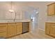 Kitchen area with white appliances, wood cabinets, and view into adjacent rooms at 430 Rehobeth Way, Fayetteville, GA 30214