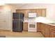 Well-equipped kitchen features wooden cabinets, stainless steel appliances, and wood-style flooring at 430 Rehobeth Way, Fayetteville, GA 30214