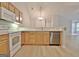 Kitchen area with white appliances, wood cabinets, and view into adjacent rooms at 430 Rehobeth Way, Fayetteville, GA 30214