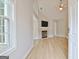 Bright living room featuring hardwood floors, a fireplace with mounted TV, and vaulted ceilings at 430 Rehobeth Way, Fayetteville, GA 30214