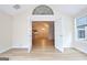 Bright living room with French doors to sunroom and view to the kitchen at 430 Rehobeth Way, Fayetteville, GA 30214