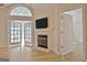 Living room with fireplace and ample natural light coming in through the French doors at 430 Rehobeth Way, Fayetteville, GA 30214