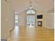 Spacious living room with fireplace, hardwood floors, ceiling fan and French doors to sunroom at 430 Rehobeth Way, Fayetteville, GA 30214