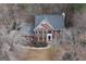 Stunning aerial view of a brick home with an expansive roof and lush surrounding trees at 155 Glenwood Ln, Fayetteville, GA 30215