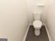 Neat bathroom featuring a standard toilet with a white porcelain finish, tiled floors, and painted walls at 155 Glenwood Ln, Fayetteville, GA 30215