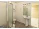 Bright bathroom with shower, toilet, pedestal sink, and medicine cabinet at 155 Glenwood Ln, Fayetteville, GA 30215
