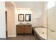 Bright bathroom featuring a double sink vanity with stone countertops, framed mirrors, and a modern white soaking tub at 155 Glenwood Ln, Fayetteville, GA 30215