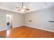 Large bedroom featuring hardwood floors, a ceiling fan, and an open layout, providing a versatile living space at 155 Glenwood Ln, Fayetteville, GA 30215
