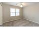 Carpeted bedroom with a ceiling fan for optimal comfort and climate control, and a large window for natural light at 155 Glenwood Ln, Fayetteville, GA 30215
