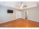 Spacious bedroom with hardwood floors, tray ceiling, and ceiling fan, offering a comfortable and stylish retreat at 155 Glenwood Ln, Fayetteville, GA 30215