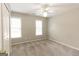 This carpeted bedroom has a ceiling fan, light-painted walls, and natural light from the windows at 155 Glenwood Ln, Fayetteville, GA 30215