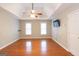 Inviting bedroom with hardwood floors, ceiling fan, and lots of light, creating a relaxing atmosphere at 155 Glenwood Ln, Fayetteville, GA 30215