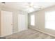 Carpeted bedroom with natural light, a ceiling fan, and closet space makes this a cozy space at 155 Glenwood Ln, Fayetteville, GA 30215