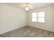 Carpeted bedroom with natural light and a ceiling fan is a cozy and inviting space at 155 Glenwood Ln, Fayetteville, GA 30215