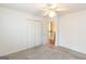 This carpeted bedroom features a ceiling fan, and closet, perfect for rest and relaxation at 155 Glenwood Ln, Fayetteville, GA 30215