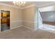 Inviting dining room with neutral carpet, chandelier and trim with kitchen view at 155 Glenwood Ln, Fayetteville, GA 30215