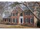 Charming brick home features a traditional design with a black front door, black shutters, and arched window at 155 Glenwood Ln, Fayetteville, GA 30215
