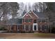 Charming brick home featuring black shutters, a well-manicured lawn, and tasteful landscaping at 155 Glenwood Ln, Fayetteville, GA 30215