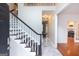 Bright foyer features a staircase with dark wood handrail and marble floors, leading into other rooms at 155 Glenwood Ln, Fayetteville, GA 30215