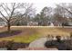 A large front yard has a winding walkway up to a large brick home at 155 Glenwood Ln, Fayetteville, GA 30215