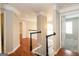 Inviting hallway featuring hardwood floors, detailed trim, and natural light, connecting various living spaces seamlessly at 155 Glenwood Ln, Fayetteville, GA 30215