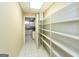 Hallway featuring built-in shelving, tile floors, and an open doorway to the kitchen at 155 Glenwood Ln, Fayetteville, GA 30215