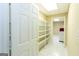 Hallway featuring built-in shelving, tile floors, and an open doorway to laundry area at 155 Glenwood Ln, Fayetteville, GA 30215