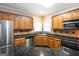 Bright kitchen with stainless steel appliances, wood cabinets, and granite counters at 155 Glenwood Ln, Fayetteville, GA 30215