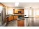 Open kitchen layout with wood cabinets, granite counters, and a view to the living room at 155 Glenwood Ln, Fayetteville, GA 30215