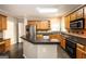 Kitchen featuring stainless steel appliances, island and black countertop at 155 Glenwood Ln, Fayetteville, GA 30215