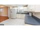 Classic kitchen with white appliances, tile floors, and adjacent living space at 155 Glenwood Ln, Fayetteville, GA 30215
