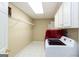 Laundry room features white appliances, tile floors, utility storage, and a light-colored paint at 155 Glenwood Ln, Fayetteville, GA 30215