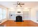 Open living room with hardwood floors, fireplace, and built-in shelving at 155 Glenwood Ln, Fayetteville, GA 30215