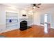 Bright living room featuring fireplace and built-in shelves, with hardwood floors at 155 Glenwood Ln, Fayetteville, GA 30215